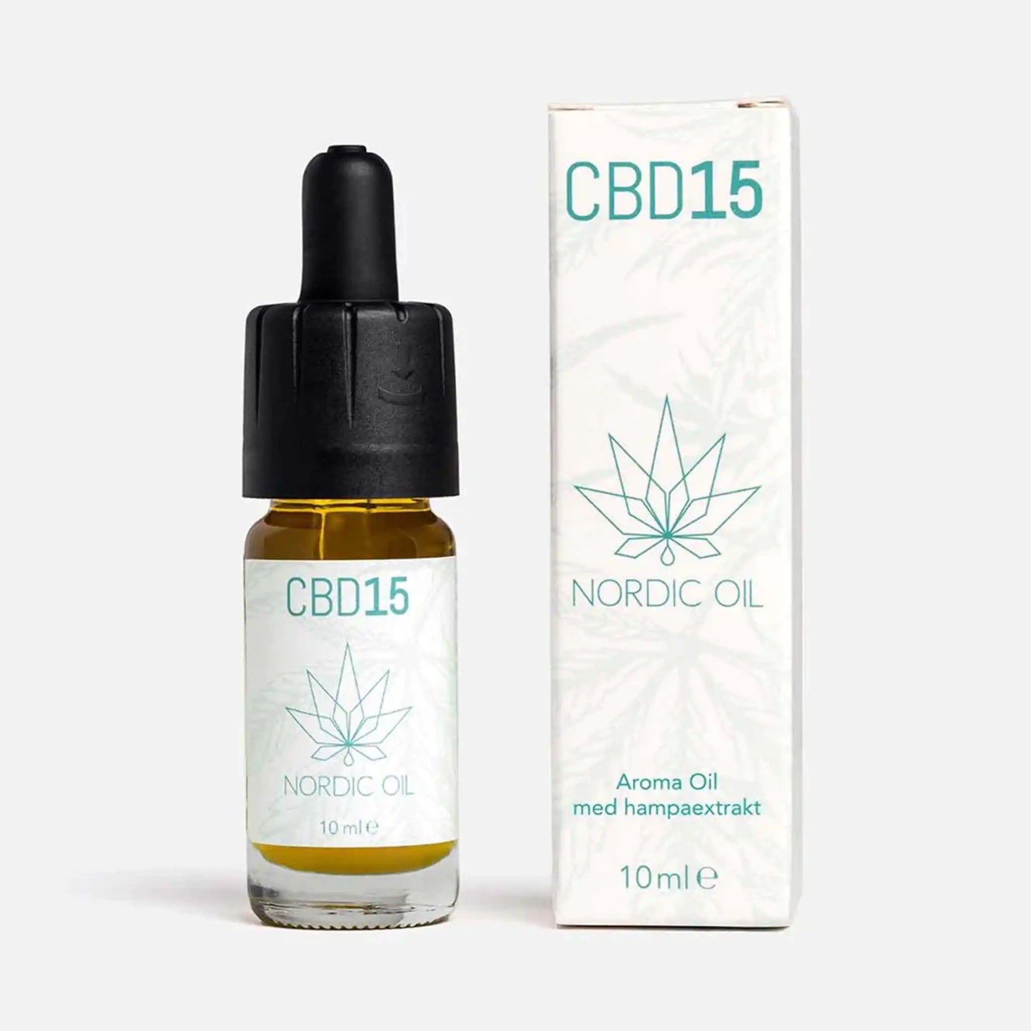 En flaska CBD Aroma Oil 15 % ovanpå sin förpackning.