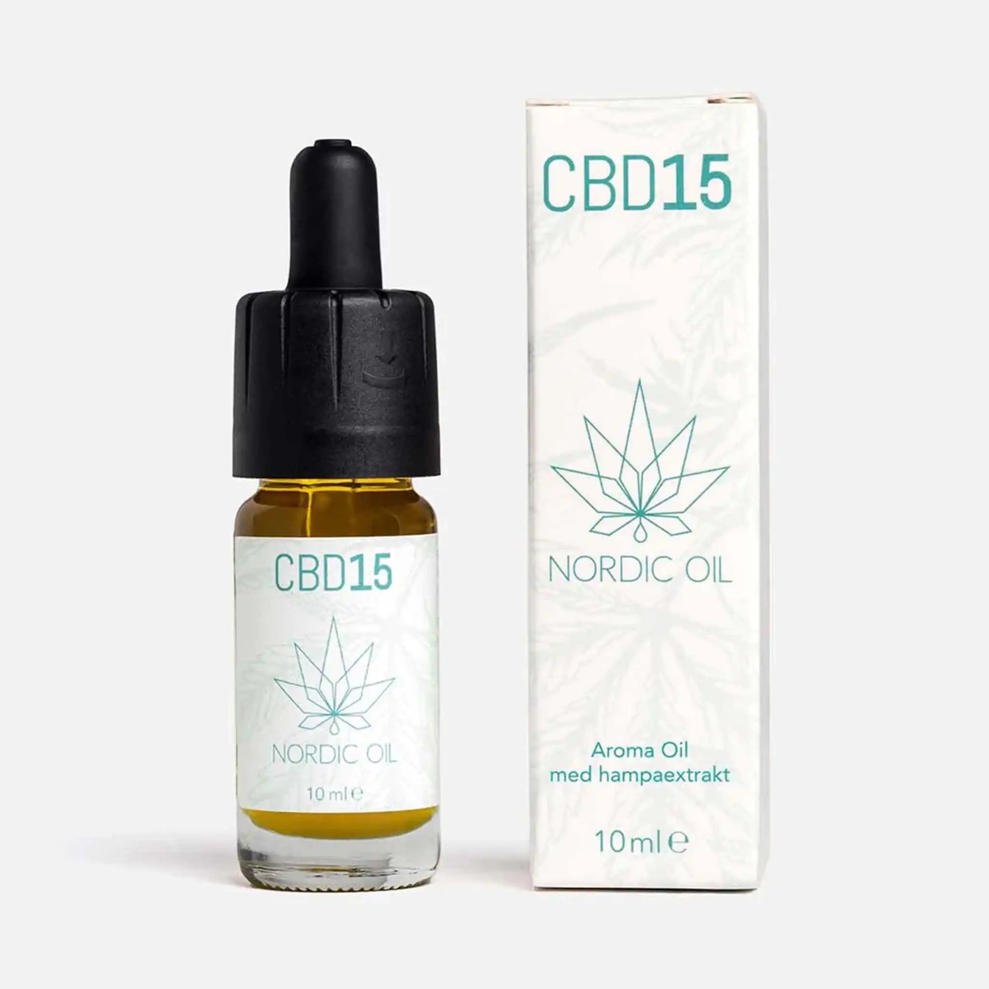 En flaska CBD Aroma Oil 15 % ovanpå sin förpackning.