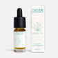 En flaska CBD Aroma Oil 15 % ovanpå sin förpackning.